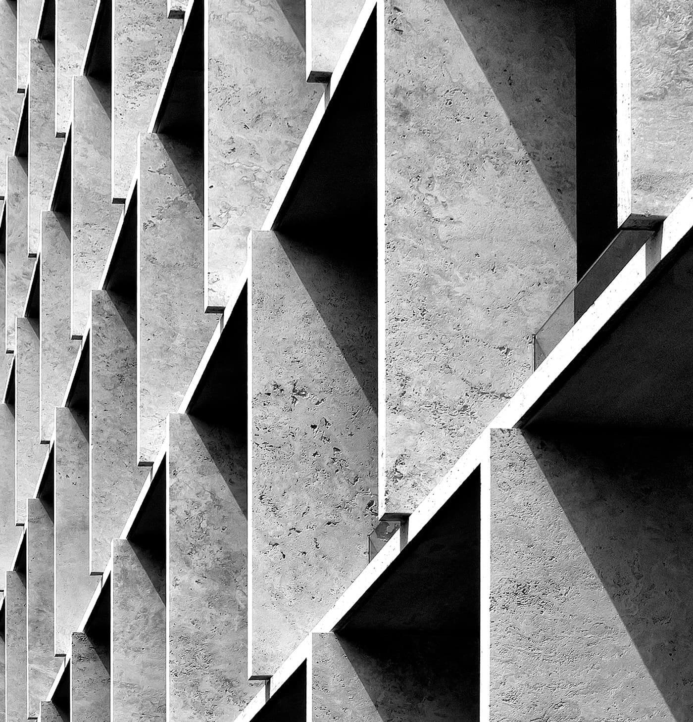 Light and shadow across a sculptural concrete facade